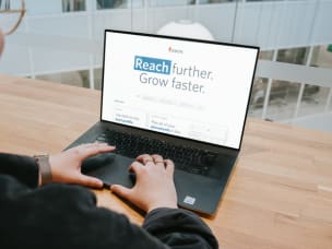 Laptop screen saying "Reach further. Grow faster." for Awin's new Winter 2024 releases