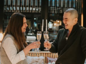 2 Awin employees have a toast in restaurant after winning 4 awards at the Performance Marketing Awards 2024