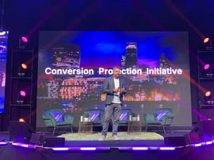  Awin's CEO, Adam Ross, on stage presenting the Conversion Protection Initiative at PI Live Europe.