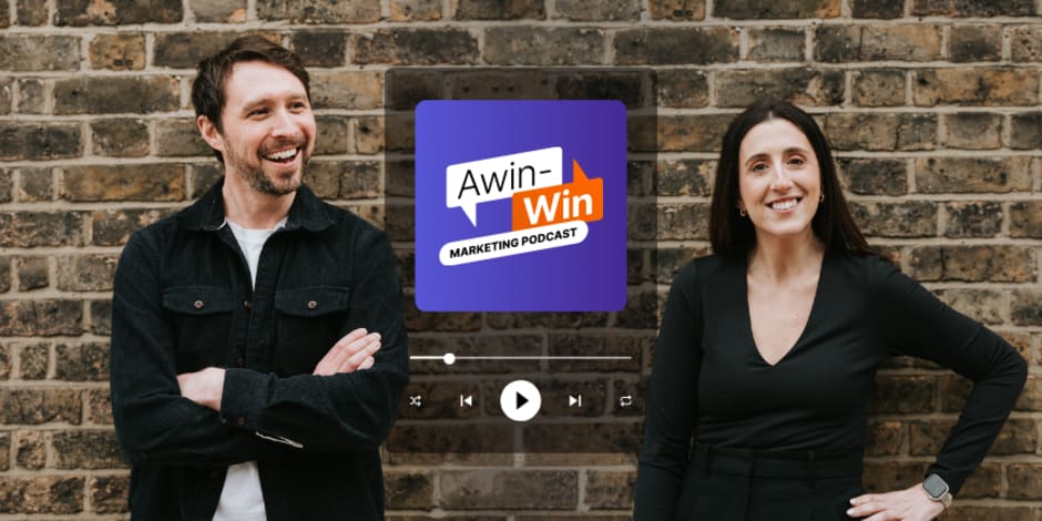 Two Awin employees standing in front of a  brick wall featuring Awin's podcast advertisement.
