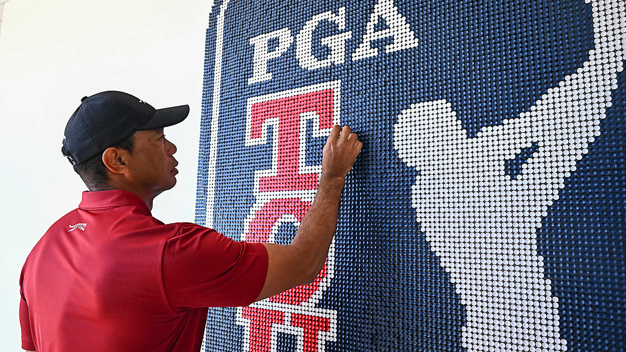 Tiger Woods adds the last tee to an art installation at PGA TOUR Studios at the PGA TOUR Global Home campus on Nov. 18, 2024, in Ponte Vedra Beach, Florida. (Chris Condon/PGA TOUR)